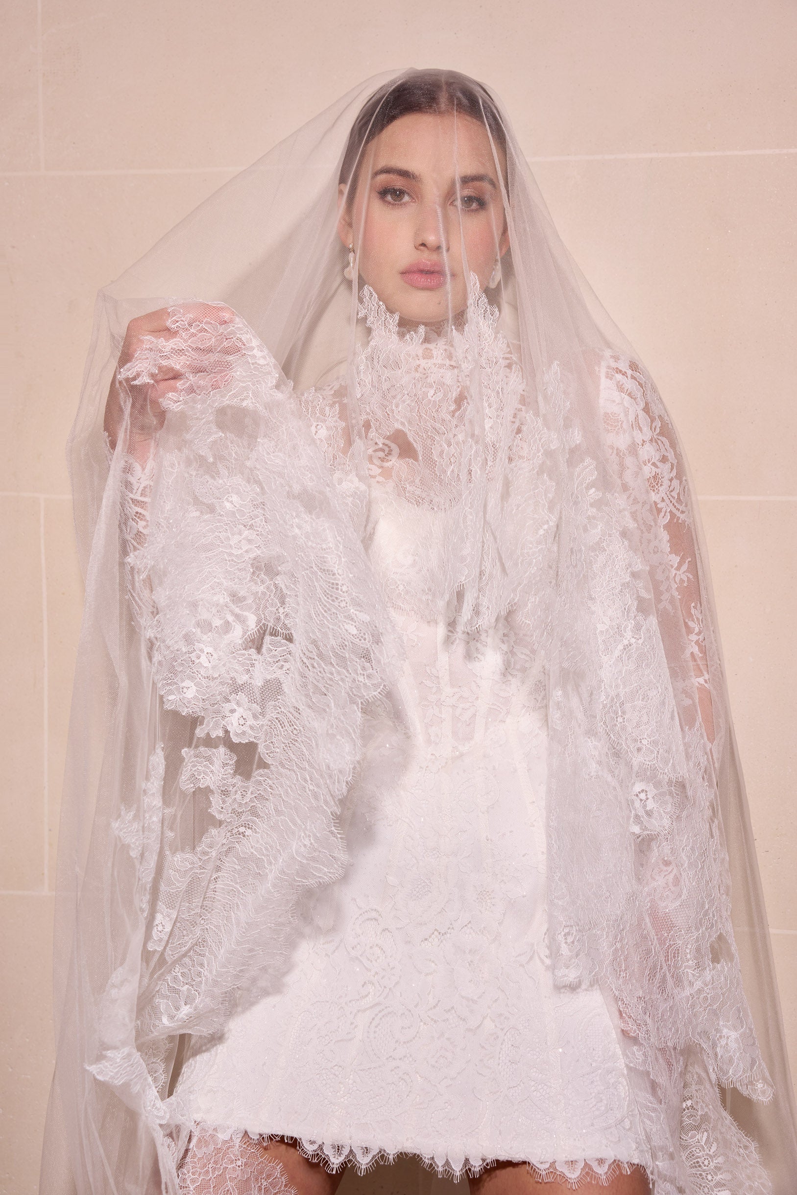 Lace mini dress with boning detail and
optional detachable matching lace jacket with matching single tier lace veil