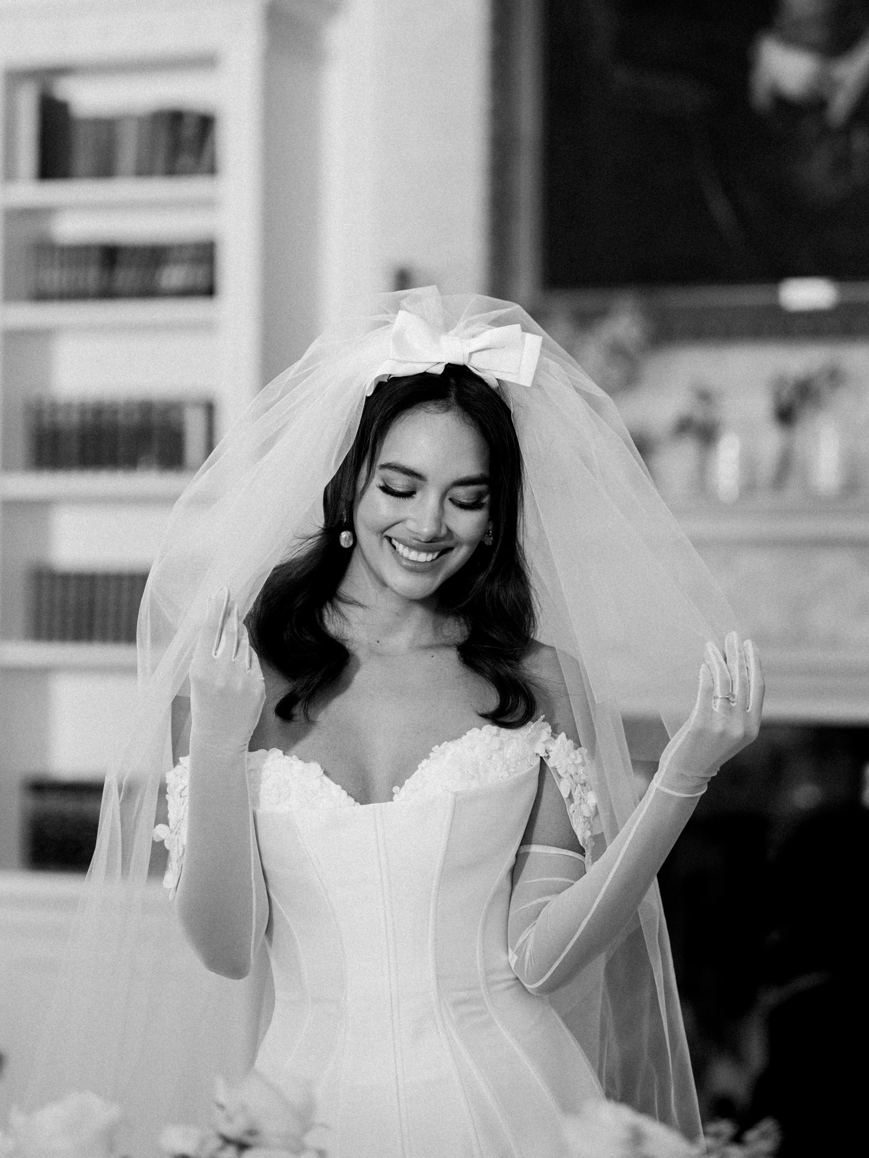 short corseted gown with beaded lace bust and straps and gloves and double tier wedding bow veil