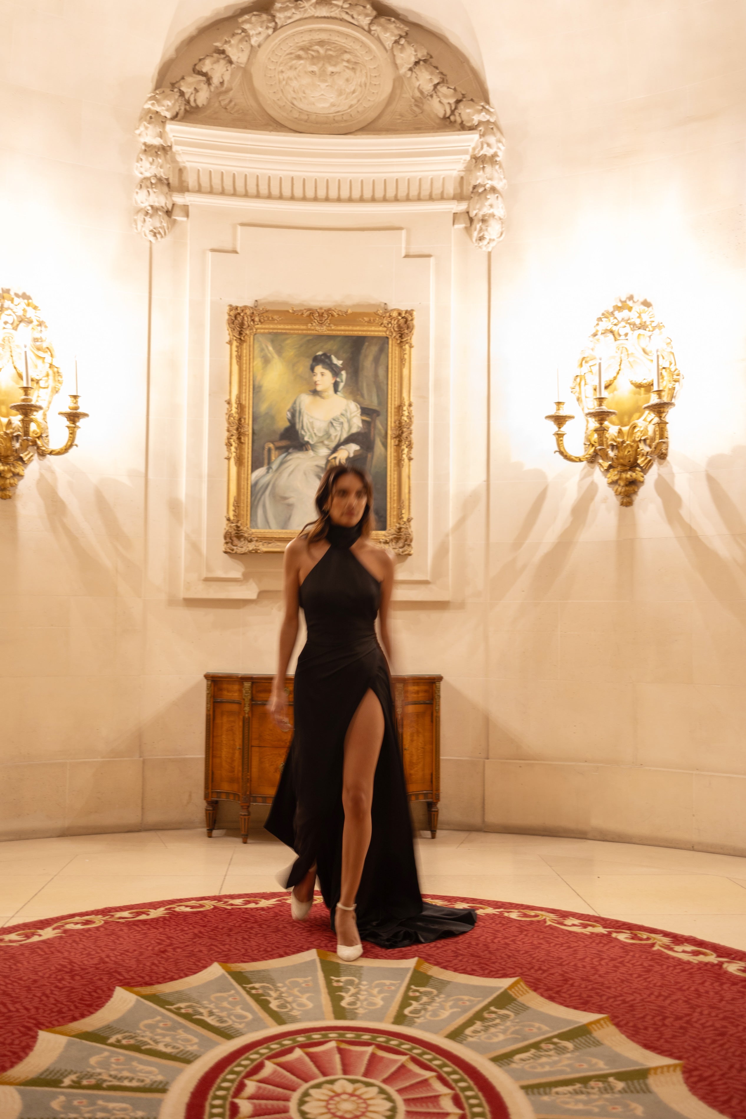 chic satin crepe black noir sheath dress with a flattering high neck and pleats and thigh high split low cut back
