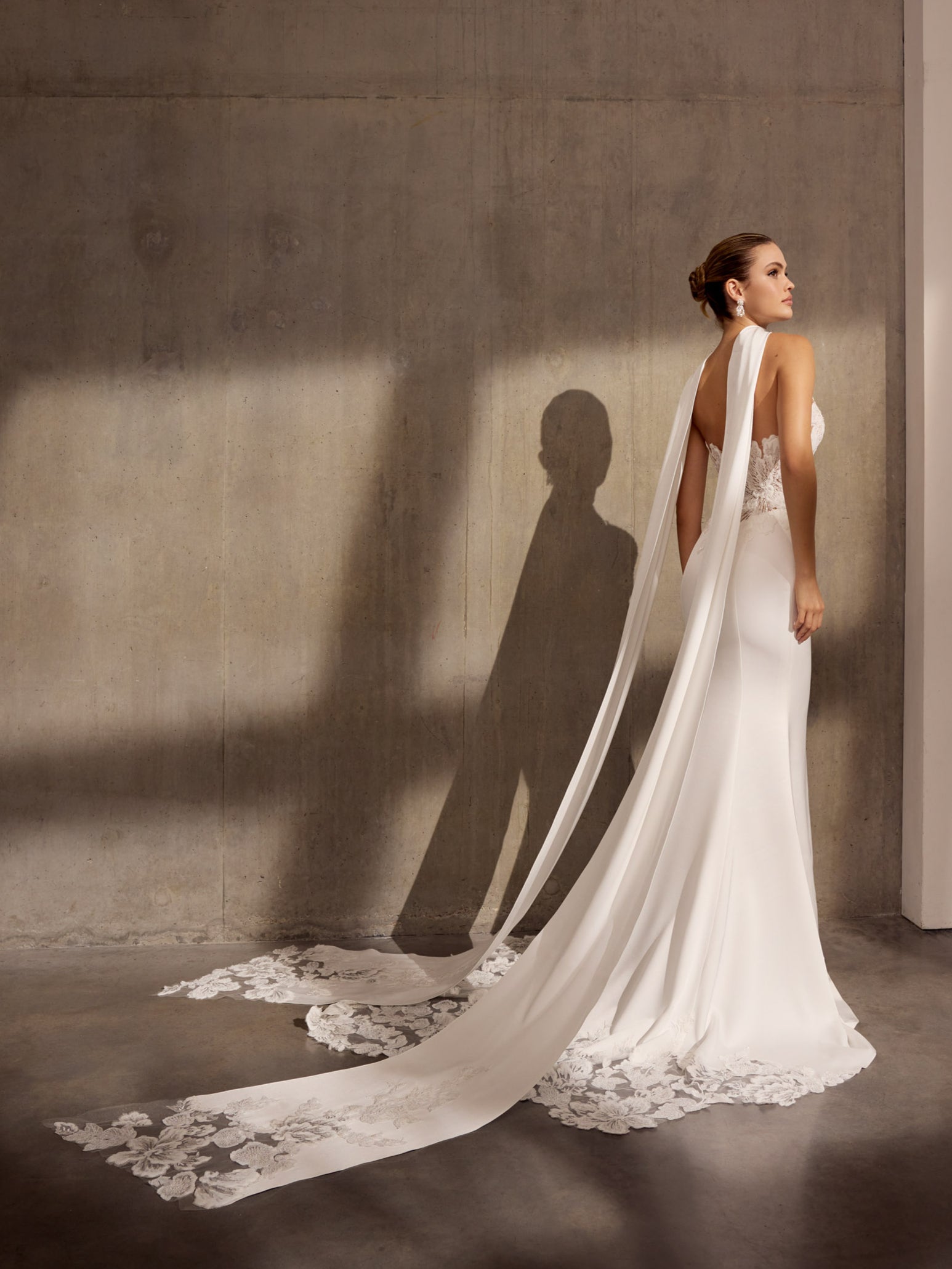 Japanese crepe sheath dress with floral
applique embellishment and illusion train.
matching lace scarf