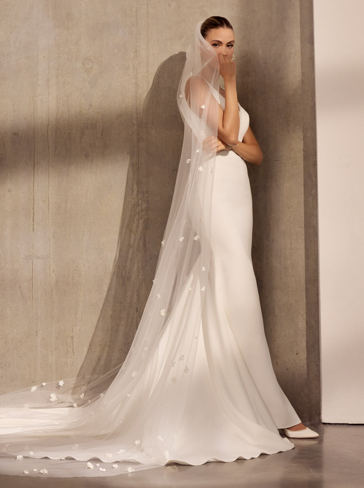 V-neck plunge Lux stretch crepe fluted sheath dress with
pearl detail with 3D flower single tier veil