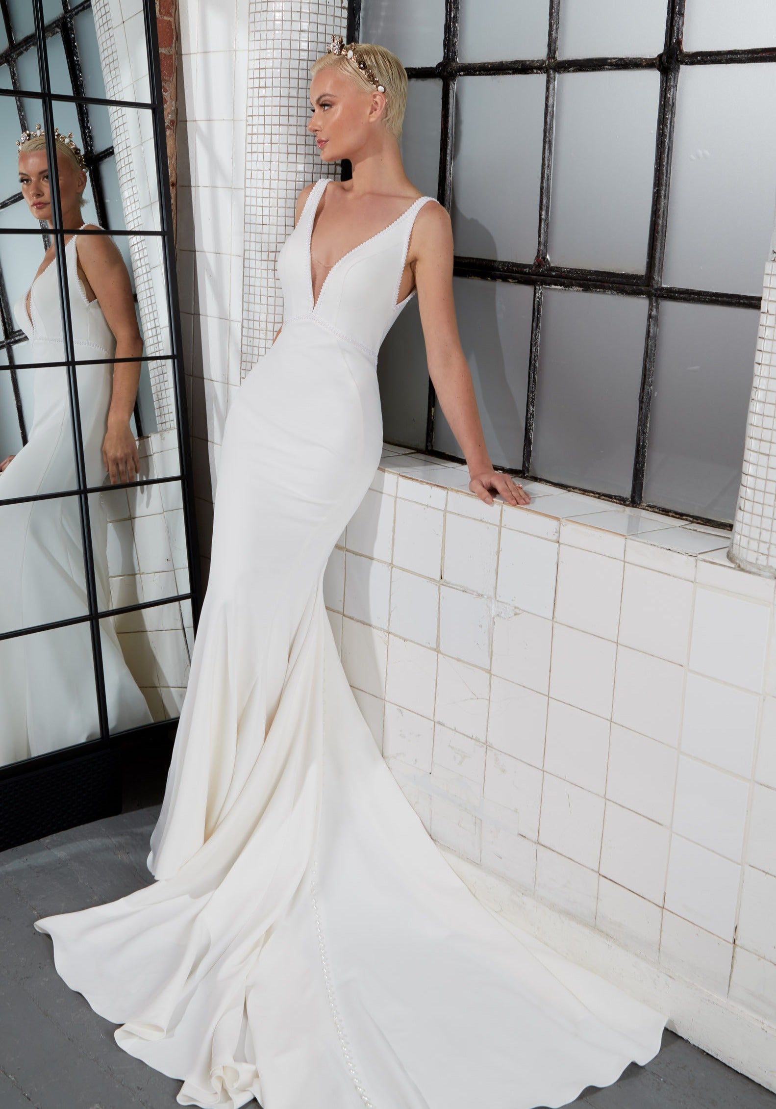lux crepe fishtail silhouette, plunge neckline with pearl trim and sleeveless