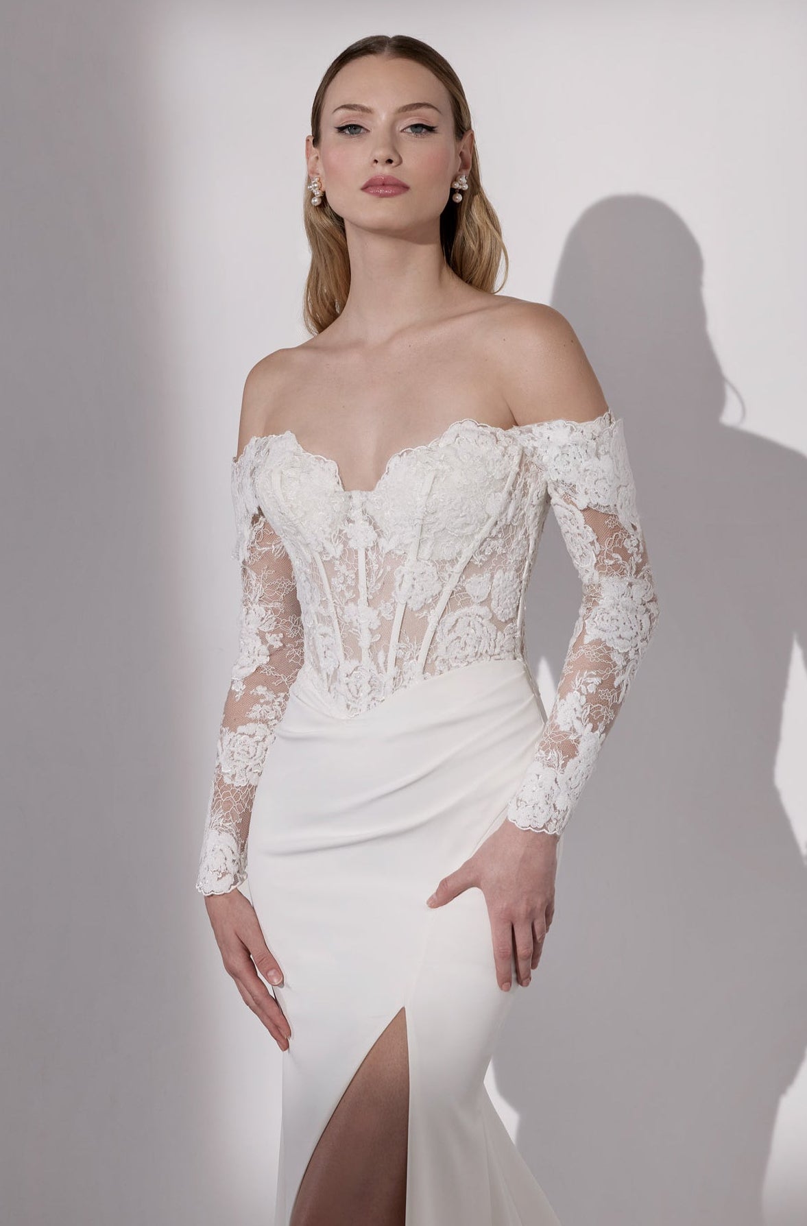 Lux stretch crepe with embellished French-
look lace detail, illusion train and sleeves