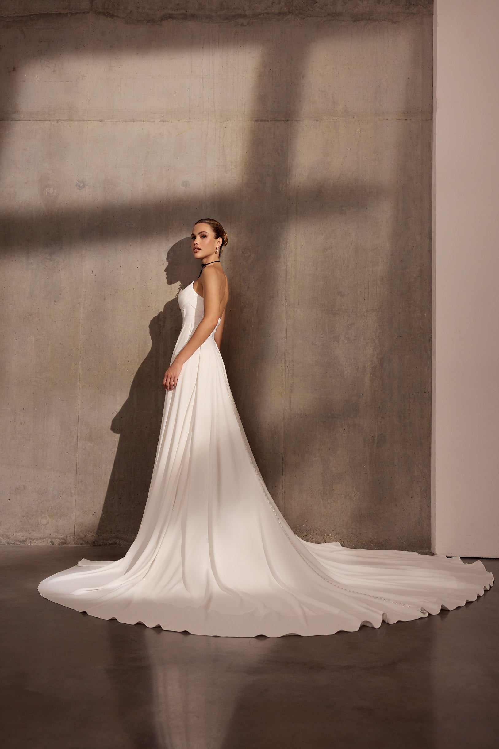 Strapless georgette draped sheath dress with corset and cathedral train