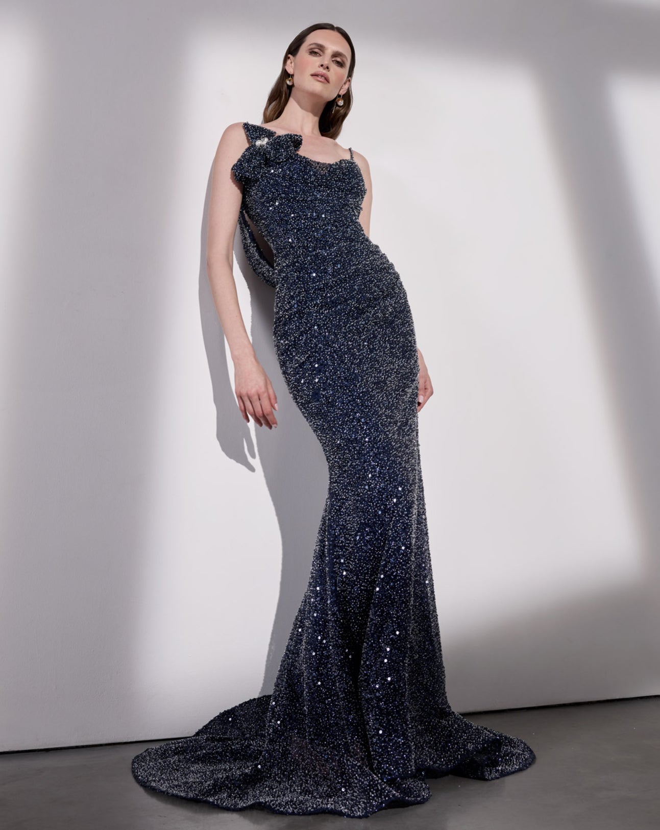 navy beaded fitted pleated and draped evening sheath dress with spaghetti straps with a floral accent and detachable cowl back