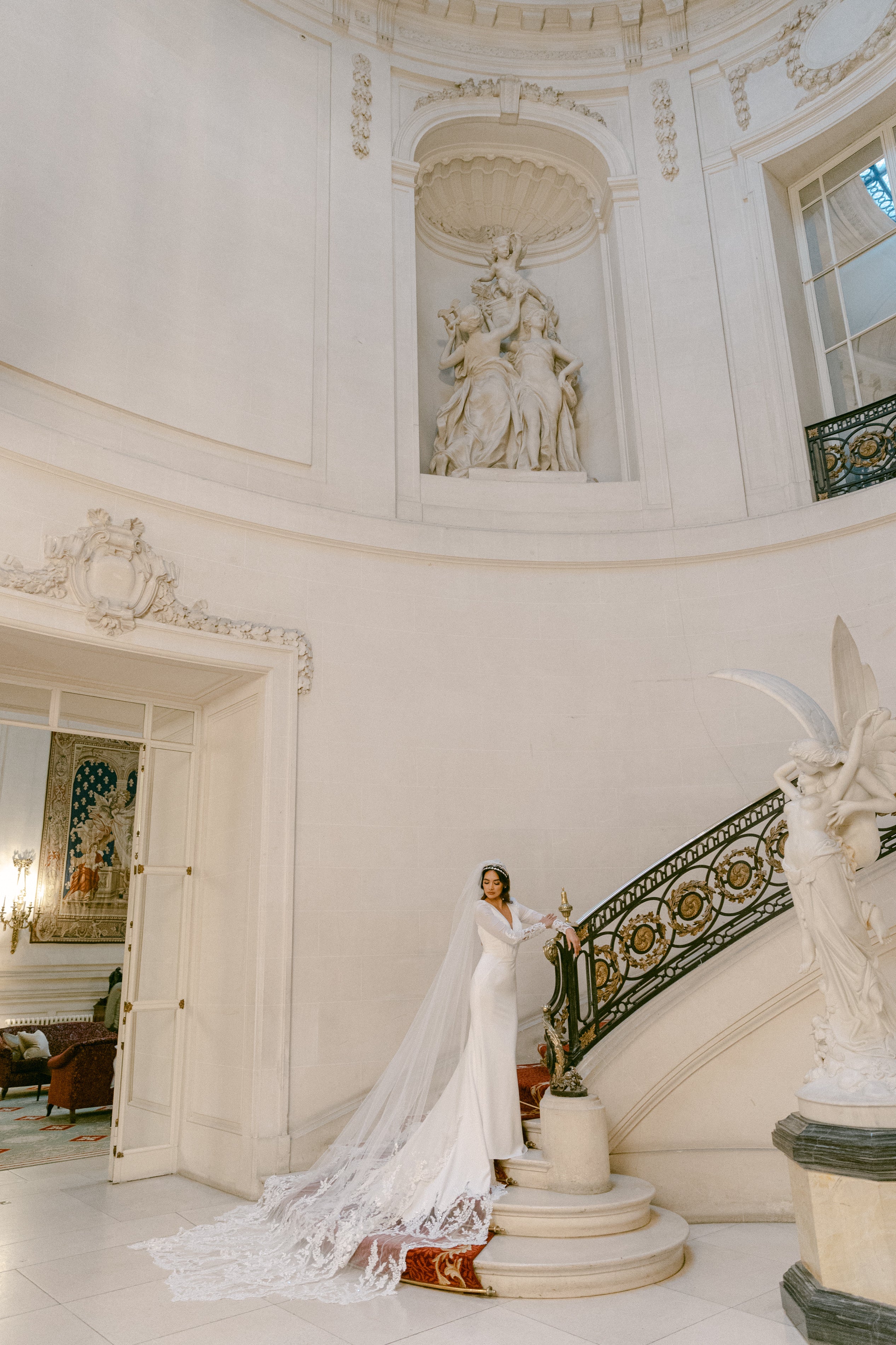 crepe plunge pleat neckline and soft fishtail silhouette with encrusted lace sleeves and train