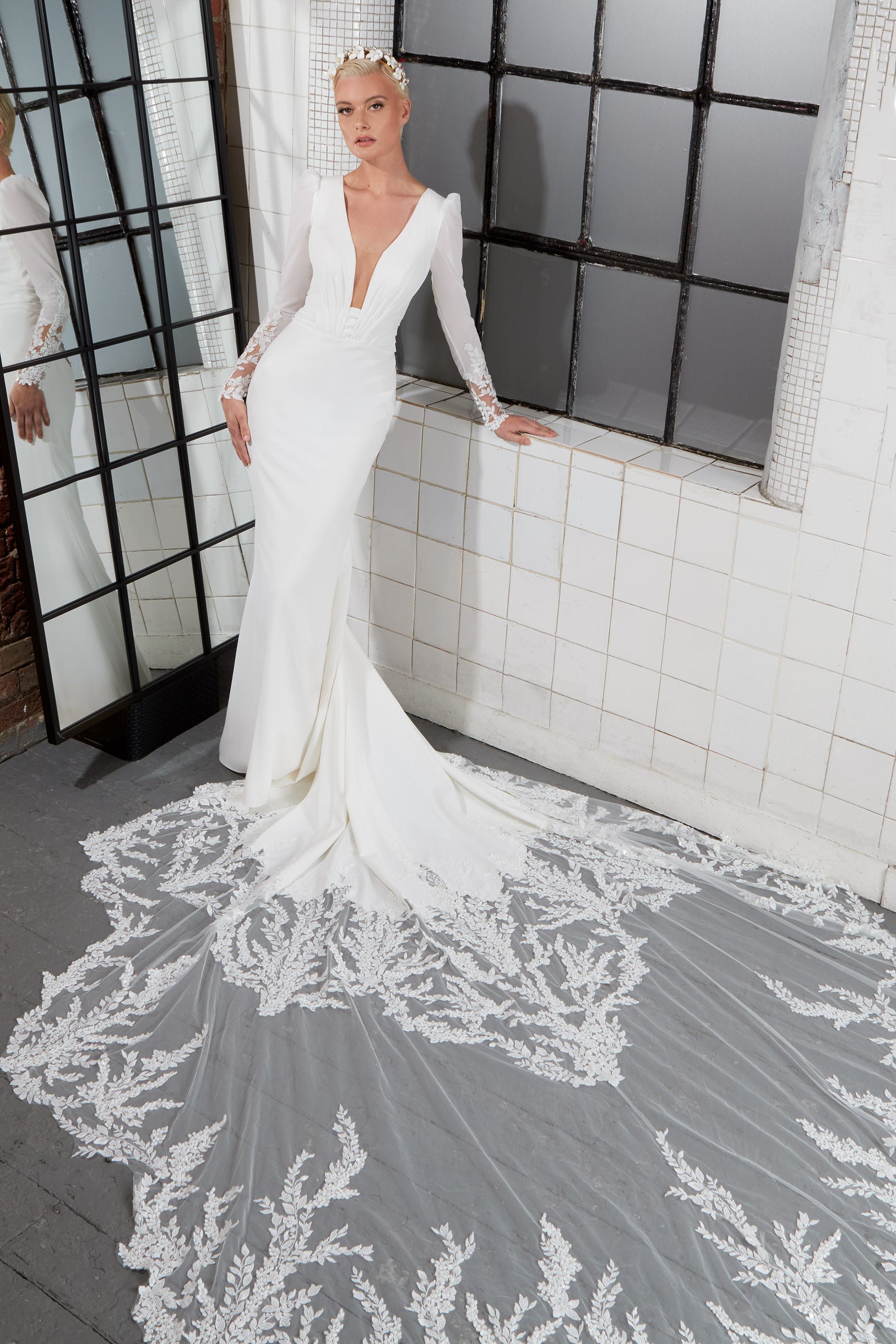 crepe plunge pleat neckline and soft fishtail silhouette with encrusted lace sleeves and train