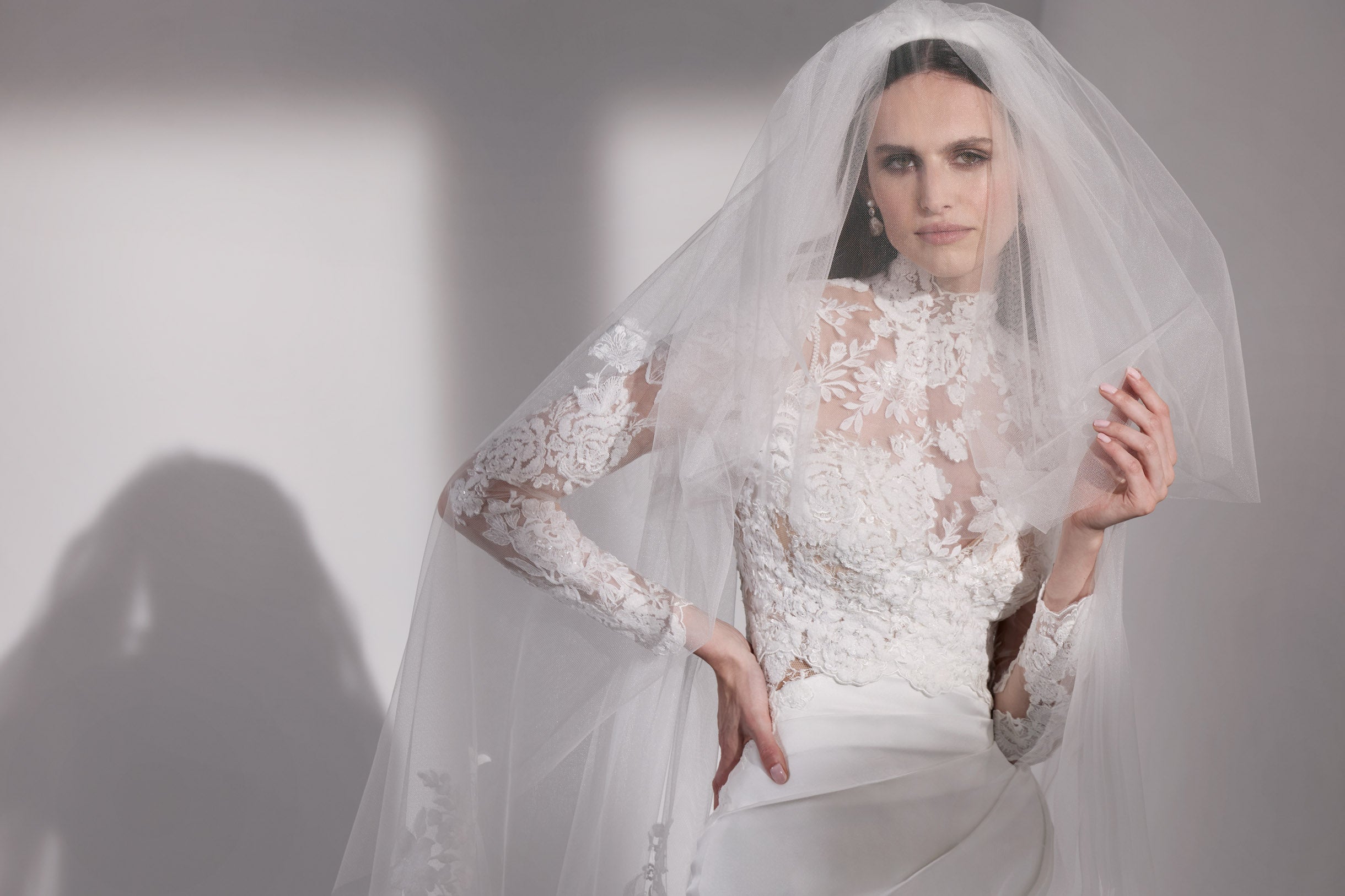 French-look embellished lace sheath dress with detachable sleeves and illusion train with double tier wedding lace veil