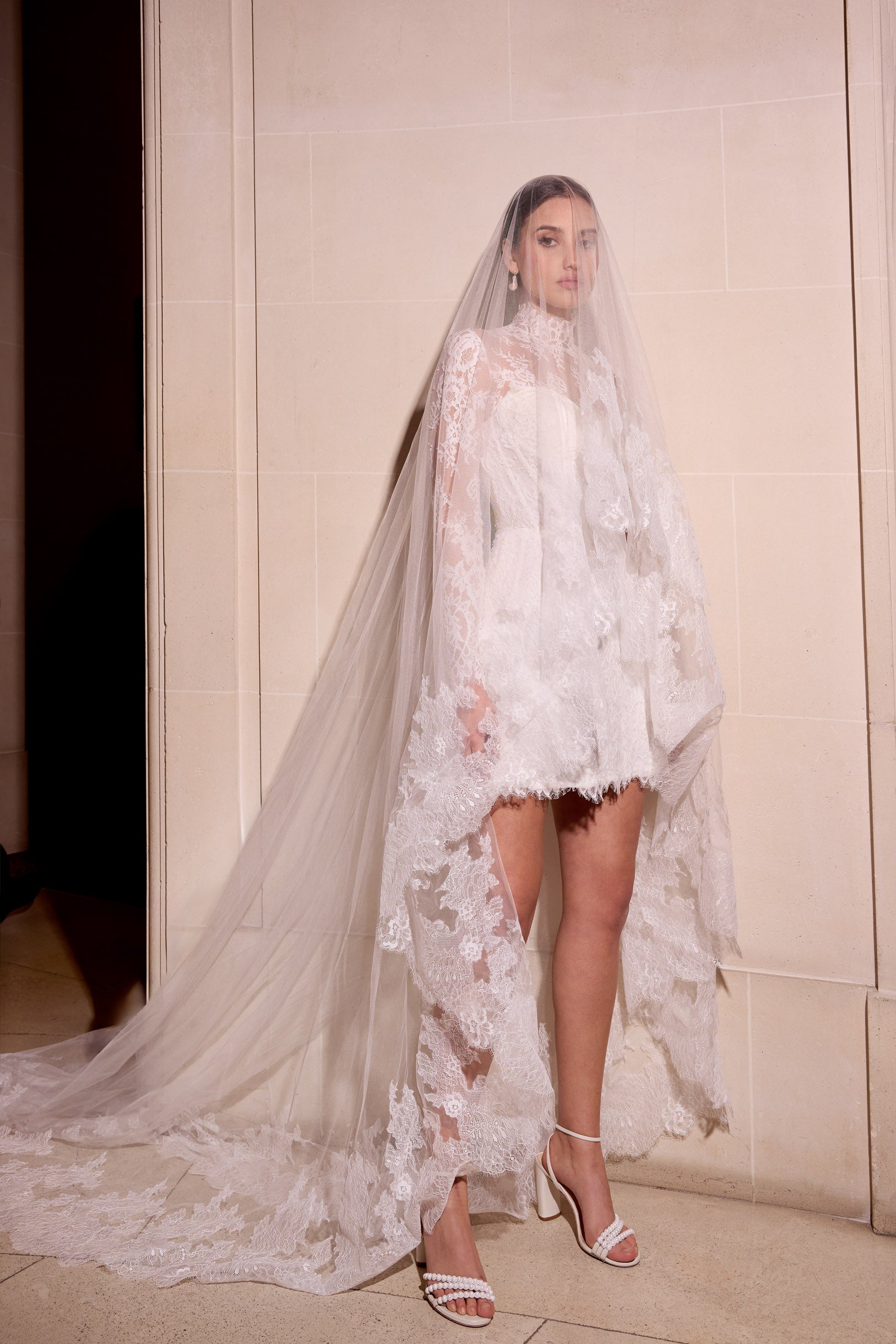 Lace mini dress with boning detail and
optional detachable matching lace jacket with matching lace single tier veil