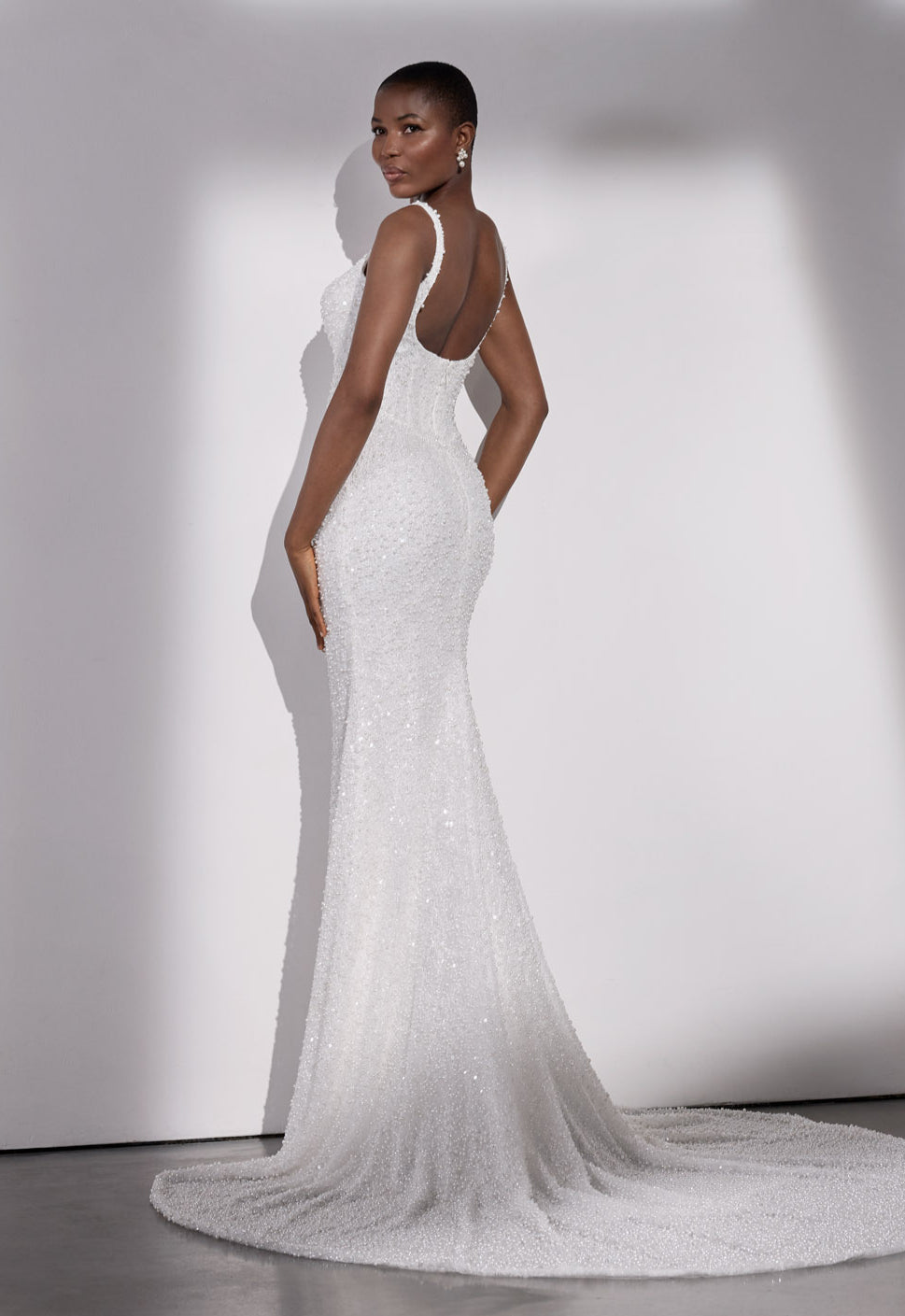 Square-neck pearl beaded sheath dress with
basque waist and detachable organza bow