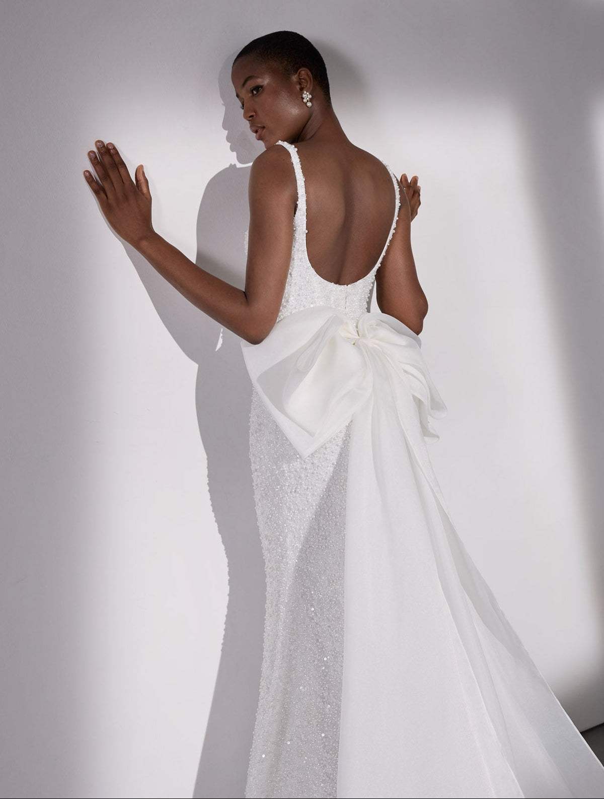 Square-neck pearl beaded sheath dress with basque waist and detachable organza bow