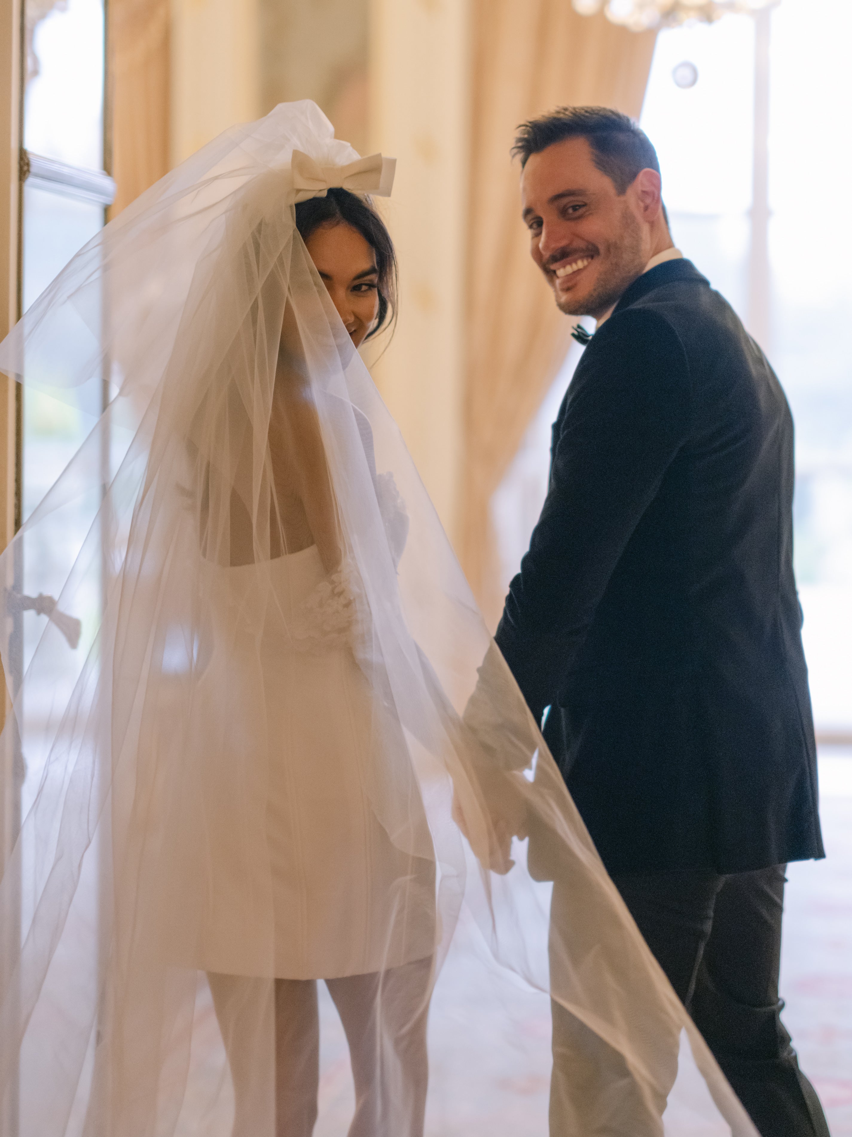 short corseted gown with beaded lace bust and straps and bow double tier wedding veil
