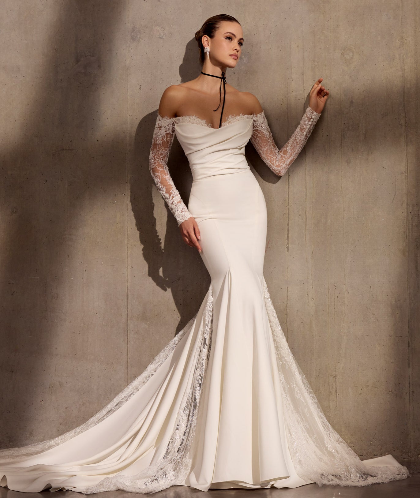 Lux stretch crepe fishtail dress with
embellished chantilly lace sleeves and
asymmetric train