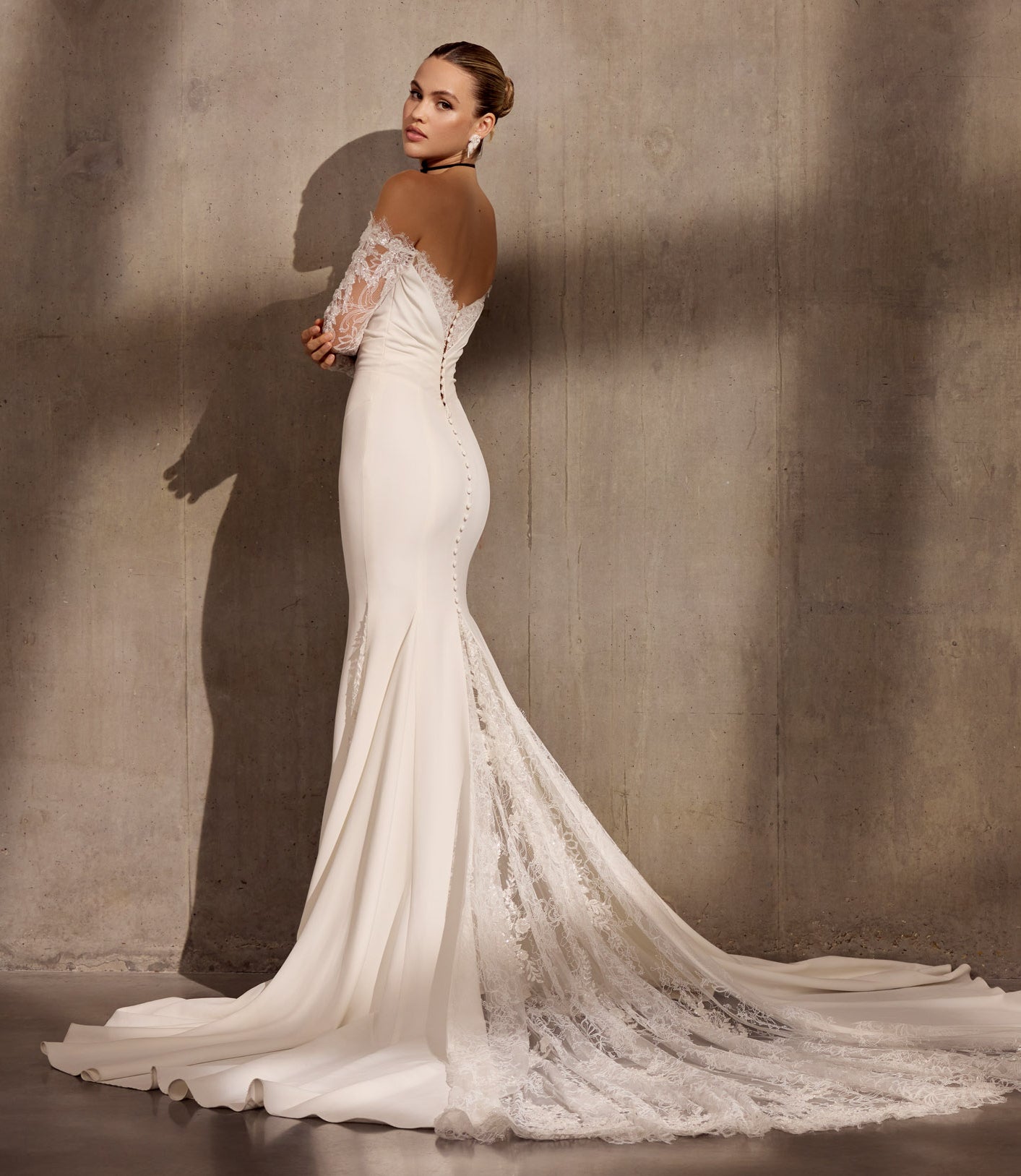 Lux stretch crepe fishtail dress with
embellished chantilly lace sleeves and
asymmetric train