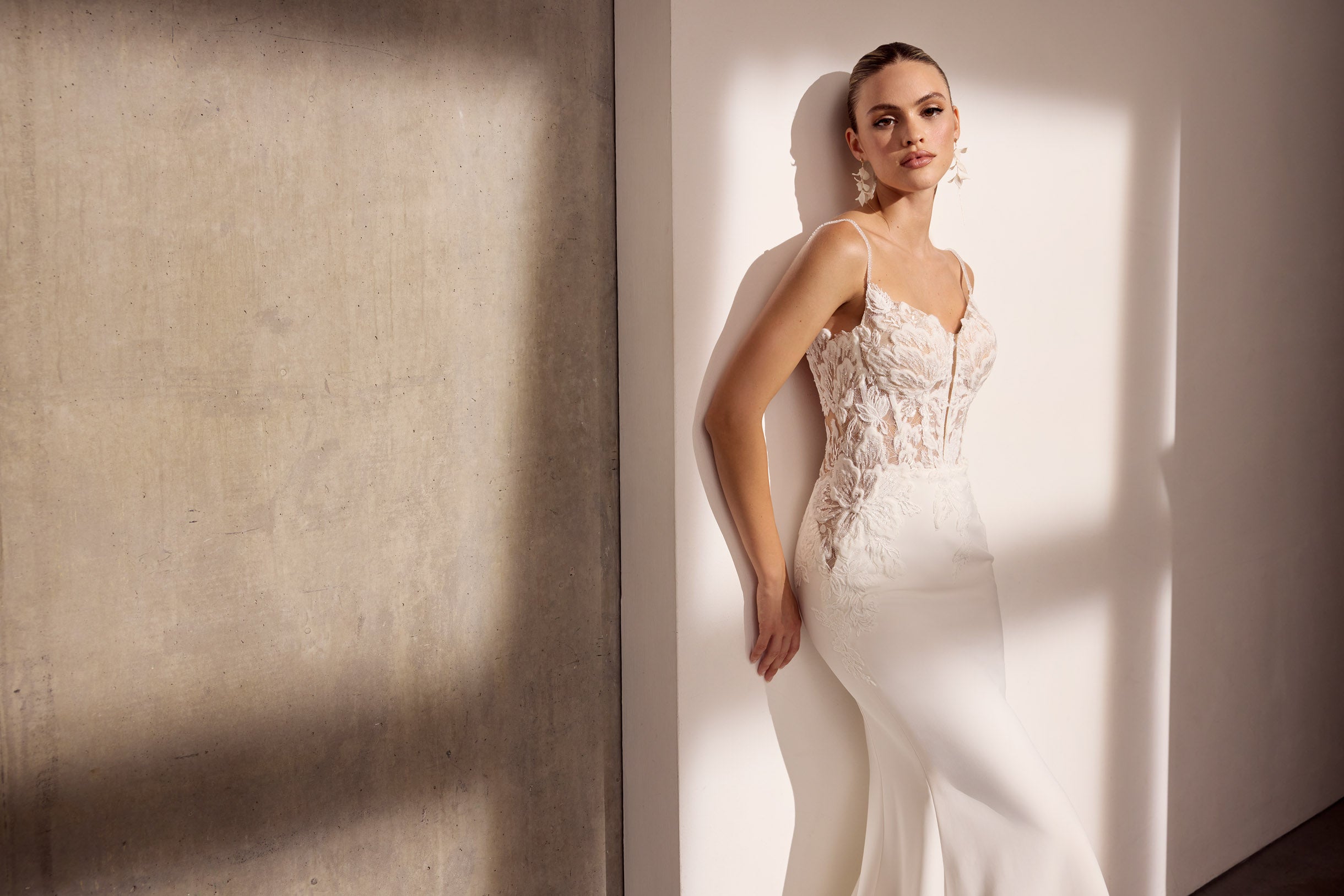 Lux stretch crepe with floral applique and
illusion train.