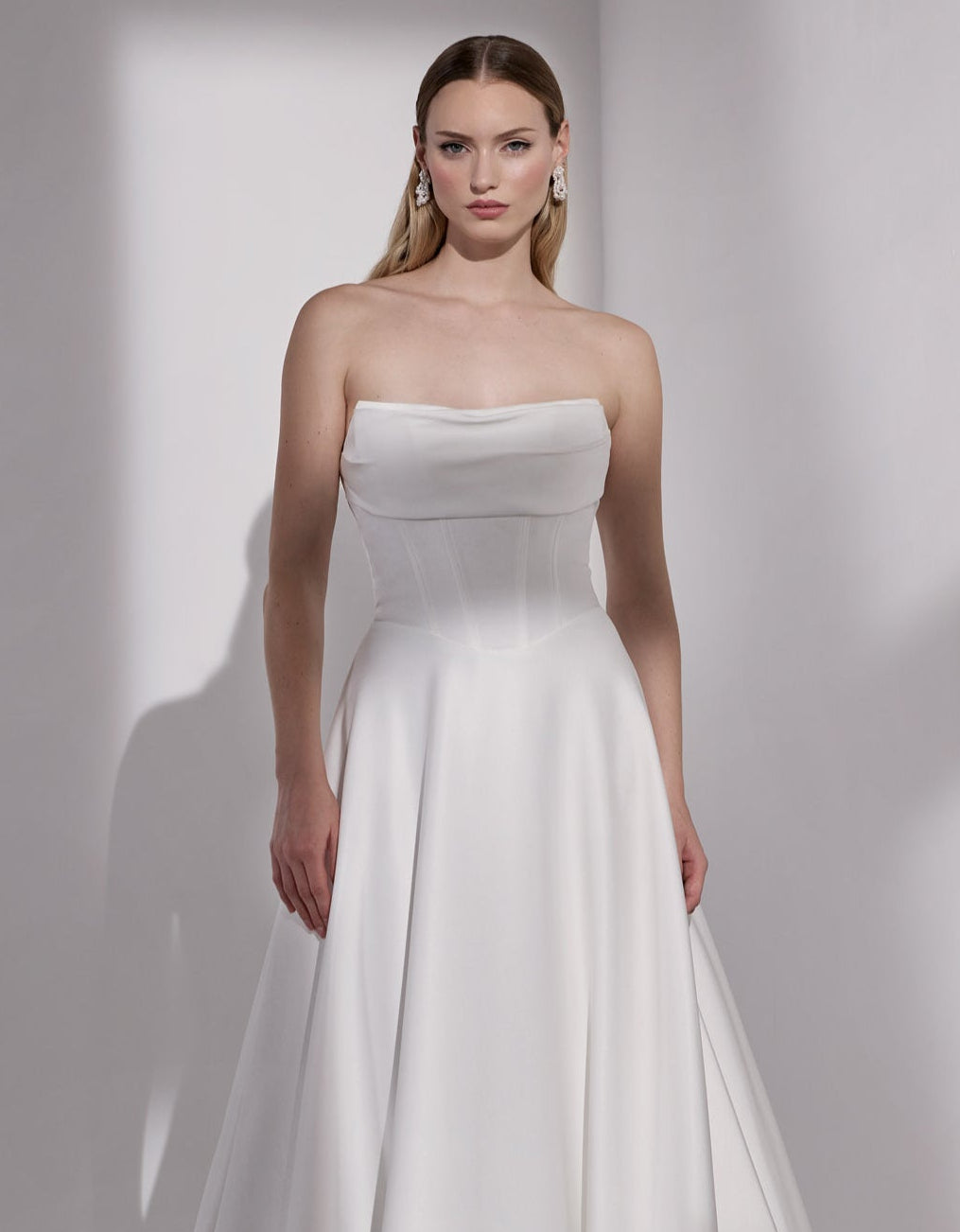 Strapless basque waist A-Line dress with
pearl button detail