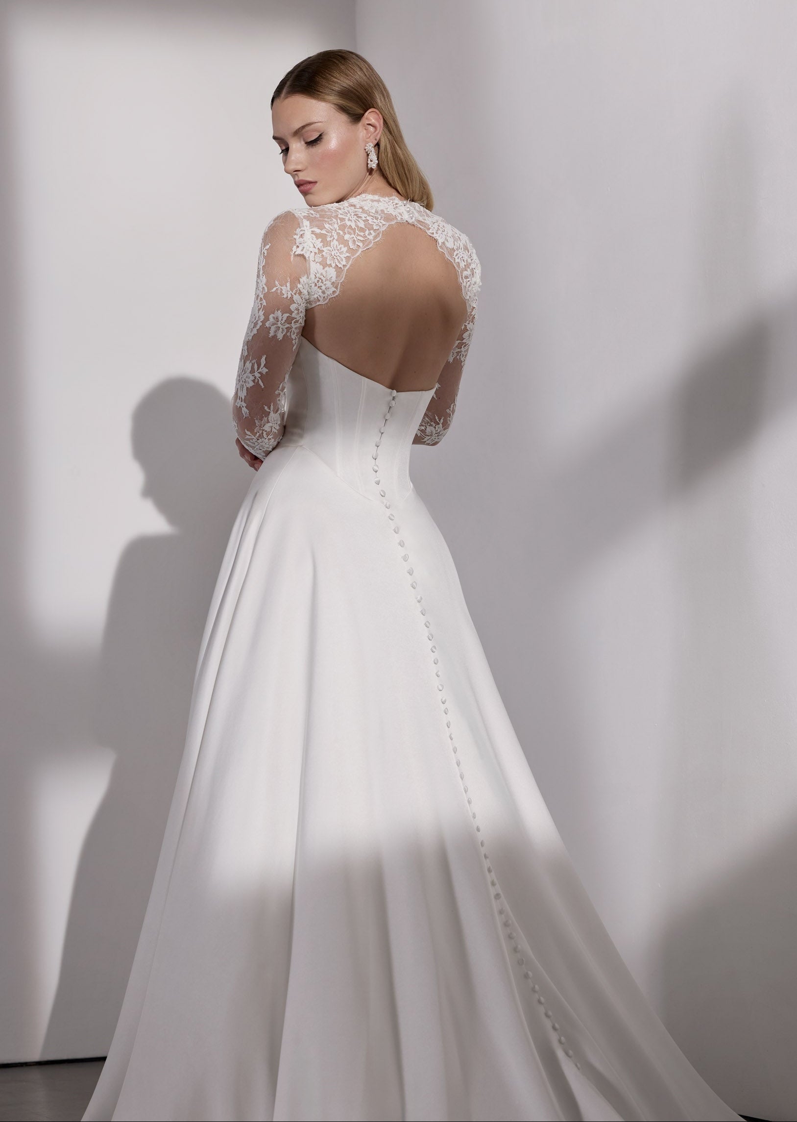 Strapless basque waist A-Line dress with
pearl button detail and lace sleeves