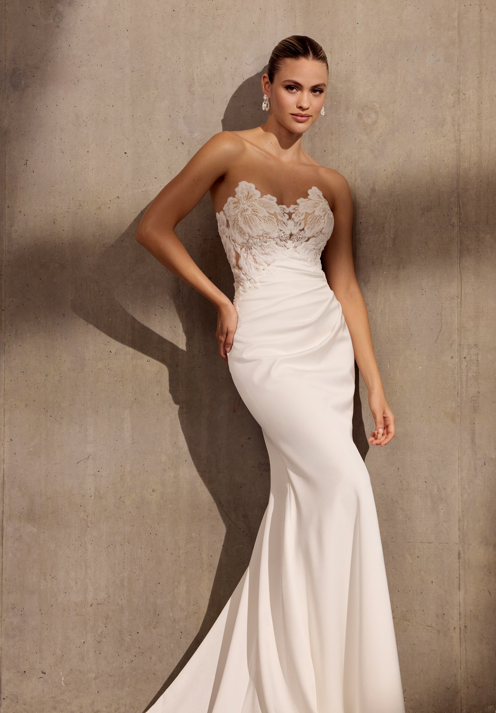 Japanese crepe sheath dress with floral
applique embellishment and illusion train.