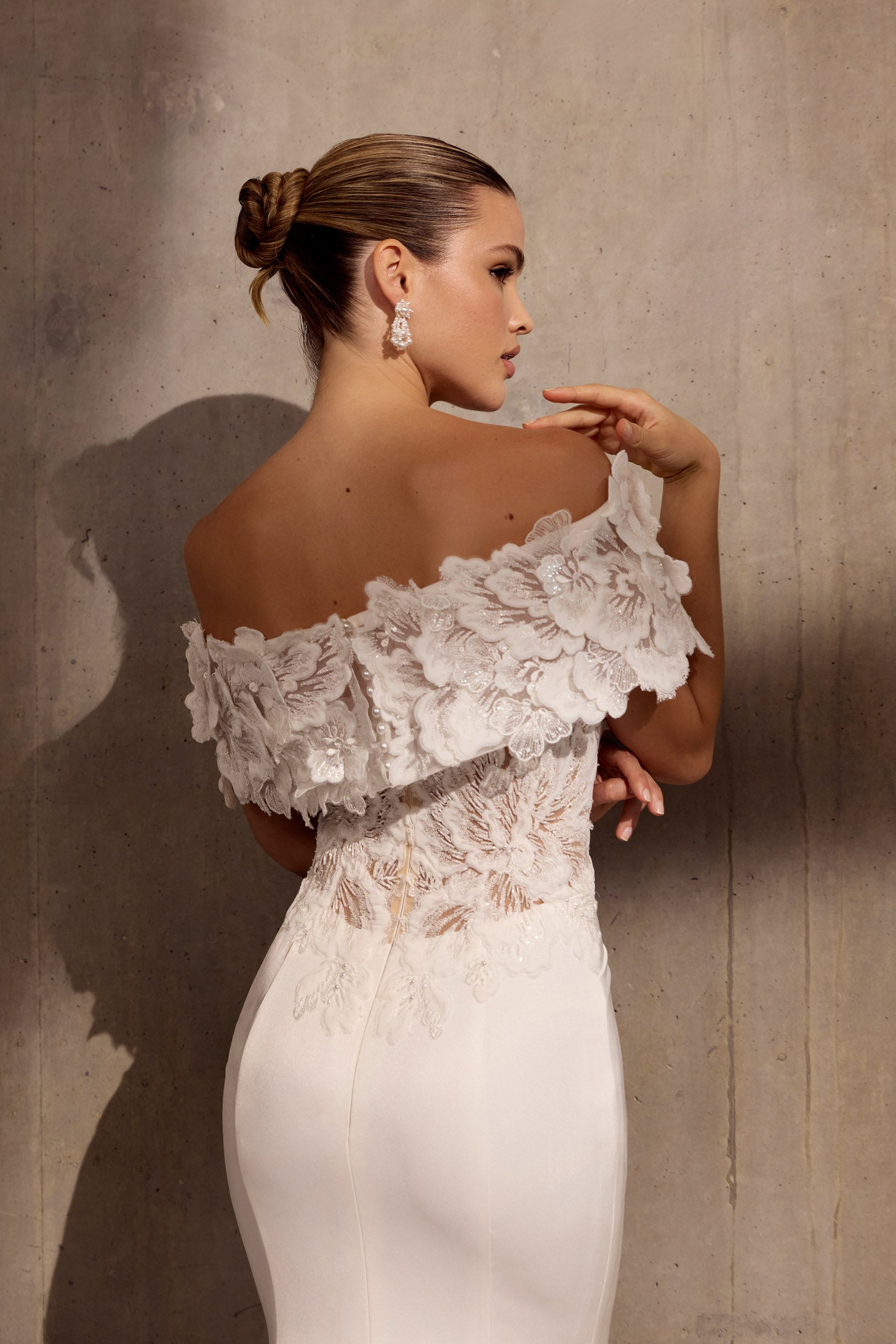 Japanese crepe sheath dress with floral
applique embellishment and illusion train.
Optional detachable applique shrug